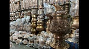 Artisan working on copperware